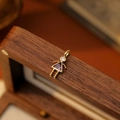 Golden girl charm pendant with a purple triangle gemstone and clear zircon head - June Girl
