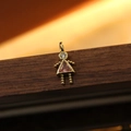 Golden girl pendant with pink triangular zircon stone and beaded limbs detail - October Girl
