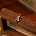 Girl pendant with red crystal gemstone and gold finish on a vintage wooden box - January Girl