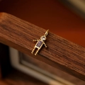 Golden boy pendant with a purple rectangular gemstone and sparkling zircon head charm - February Boy