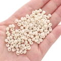 Creamy white 5mm glass seed beads for DIY jewelry making held in person hand - Beige Approx. 5x5mm Pore Size Approx. 1mm 10g/pack Approx. 100 Pieces