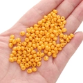Vibrant yellow 5mm glass seed beads for DIY jewelry making held in a palm - Orange-yellow Approximately 5x5mm Pore Diameter Approximately 1mm 10g/pack Approximately 100 Pieces.
