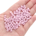 Macaron pink 5mm glass seed beads for DIY jewelry making held in palm of hand - Light Pinkish-purple Approximately 5x5mm Pore Diameter Approximately 1mm 10g/pack Approximately 100 Pieces.
