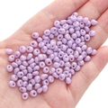 Bulk 5mm purple glass seed beads in a hand for DIY jewelry making and crafts - Purple Approx. 5x5mm Pore Size Approx. 1mm 10g/pack Approx. 100 Pieces