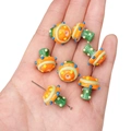 Handmade orange and green mushroom lampwork beads for DIY jewelry making and necklaces - 1 Piece (Approx. 17x16mm) / Orange with Blue and Yellow Dots Mushroom