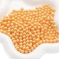 Champagne orange round ABS imitation pearls in a white dish for DIY jewelry making - Gold Yellow