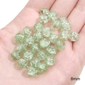 Green 8mm crackle glass beads for DIY jewelry making shown in hand with texture detail - Transparent Floral Round / 8mm / Green