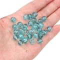 Macro view of blue crackle glass beads with pre-drilled holes for DIY jewelry making - Cracked Blue