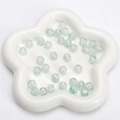 Light blue crackle glass round beads for DIY handmade jewelry in a white floral dish - Green