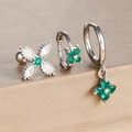 Macro shot of silver clover earrings set with green cubic zirconia on golden display stand - Silver-Green (Y26109-8)