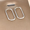 Close-up of minimalist silver horseshoe hoop earrings with secure spring closure mechanism - Oval Hoop / Silver Style (E1295-7)