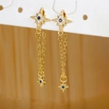 Detail of gold star earrings with blue zircon center and elegant long chain tassels - North Star Tassel Style (E1179-1) / Gold