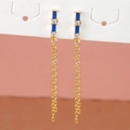 Detail of gold star earrings with blue crystals and long chain tassels on white card - Rectangular Blue Gem Double Chain Tassel Style (E1179-4) / Gold