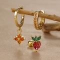 Detail of clover and strawberry zircon earrings on a wooden branch display - Strawberry Style (Y26118-3) / Gold