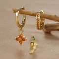Detail of clover zircon drop earrings and stud set displayed on a natural branch - Geometric Arc (Y26118-10) / Gold