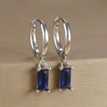 Macro shot of silver-plated earrings featuring deep blue rectangular zircon drops in 4-prong setting - Rectangular Gemstone Hoop (Y20278) / Silver-Dark Blue