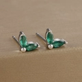 Macro shot of silver studs with marquise-cut deep green gemstones in a leaf shape - Marquise Double Zirconia Leaf Stud (Y20283) / Silver-Green