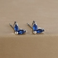 Macro shot of marquise-cut blue gemstone leaf earrings on a golden brushed base - Marquise Double Zirconia Leaf Stud (Y20283) / Silver-Dark Blue