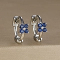Macro detail of silver floral hoop earrings with blue cubic zirconia four-leaf clover - Four-petal Flower Hoop (Y20309) / Silver-Dark Blue