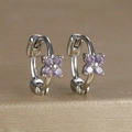 Detailed macro view of silver flower huggie earrings with purple cubic zirconia stones - Four-petal Flower Hoop (Y20309) / Silver - Purple