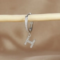 Macro shot of silver letter H earrings with micro-pave cubic zirconia on a wooden stand - 1 Piece / Silver-Letter H