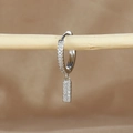 Macro detail of silver tone hoop earrings with pavé cubic zirconia on wooden branch - 1 Piece / Silver-Letter I