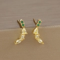Close-up of gold stud earrings with elegant curved lines and colorful zircon gemstones - Banana Shape