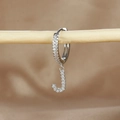 Macro shot of silver letter J hoop earring with cubic zirconia on a wooden branch - 1 Piece / Silver-Letter J