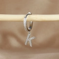Detail view of silver hoop earring with iced out letter K pendant and cubic zirconia - 1 Piece / Silver-Letter K