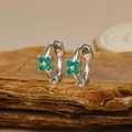Macro shot of silver-plated geometric hoop earrings with four-leaf green zircon flowers - Silver Four-petal Flower Green Zircon Hoop Earrings (Y20309)