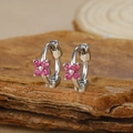 Macro view of silver geometric flower hoop earrings with pink zircons on wood bark - Silver Four-petal Flower Red Zircon Hoop Earrings (Y20309)