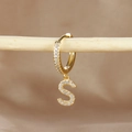 Detailed close-up of gold-plated letter S earring with micro-pave cubic zirconia on wood - 1 Piece / Gold - Letter S
