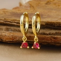 Detailed macro view of gold huggie hoop earrings featuring a round red zircon pendant - Gold Round Red Zircon Pendant Hoop Earrings (Y20301)