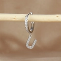 Detailed macro view of silver hoop earring with letter U pendant and micro zircon inlay - 1 Piece / Silver-Letter U