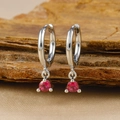 Macro shot of silver hoop earrings with vibrant red ruby gemstones in 3-prong settings - Silver Round Red Zircon Pendant Hoop Earrings (Y20301)