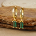 Macro detail of gold hoop earrings with emerald-cut green zircon on wood texture - Gold Rectangle Green Zircon Pendant Hoop Earrings (Y20278)