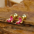 Macro shot of gold-plated stud earrings featuring red zircon marquise petals on wood background - Gold Three-petal Marquise Red Zircon Stud Earrings (Y20284)