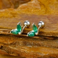 Macro shot of silver stud earrings with marquise-cut green gems on rustic bark surface - Silver Two-petal Marquise Green Zircon Stud Earrings (Y20284)