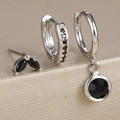Detail shot of silver earrings set with micro-paved black zircon stones and studs - Silver-Black