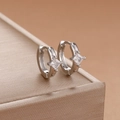 Detail view of silver sun hoop earrings with square zircon stone on jewelry box - Square Stone Style-Silver (Y26141)