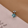 Close-up of floral silver cartilage stud with sky blue stones and screw ball back - Silver Sky Blue Flower Style (E1240-3)
