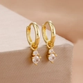 Elegant gold hoop earrings with tiered cubic zirconia drops on a warm display background - Gold Tiered Double Stone Drop Style (Y26820)