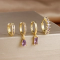 Detail view of four-piece gold earring set with rectangle and drop purple zircons - 4-Piece Set / Purple