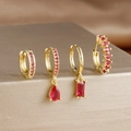 Detailed view of four gold-plated earrings set with radiant red faceted gemstones - 4-Piece Set / Red