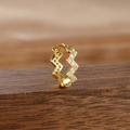 Macro shot of gold-plated zigzag hoop earrings with cubic zirconia on wood - Style 7 Zigzag Wave (7-Gold-White-1pc)