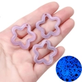 Close-up of a luminous star charm in purple with fine glitter and cutout for DIY jewelry - 10 Pieces Pack / Purple