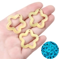 Handheld view showing luminous acrylic star pendants with glitter and blue night glow effect - 10 Pieces Pack / Yellow