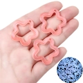 Glow-in-the-dark hollow star acrylic charms for DIY jewelry making shown in hand - 10 Pieces Pack / Pink