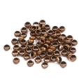 Close-up of vintage bronze spacer beads with hollow ring structure and aged texture - Antique Red Copper