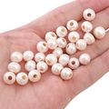 Macro shot of pre-drilled cream white natural freshwater pearls for DIY jewelry making - Thick Flat Bead (9-10mm) / White